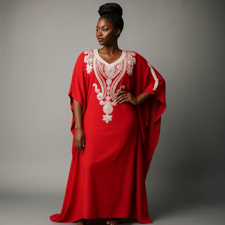 Caftan marocain rouge envoûtant avec broderies ivoire porté par une femme africaine élégante.